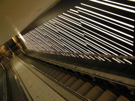Detail View of Striped Striated Backlit Wall Panels at Escalator