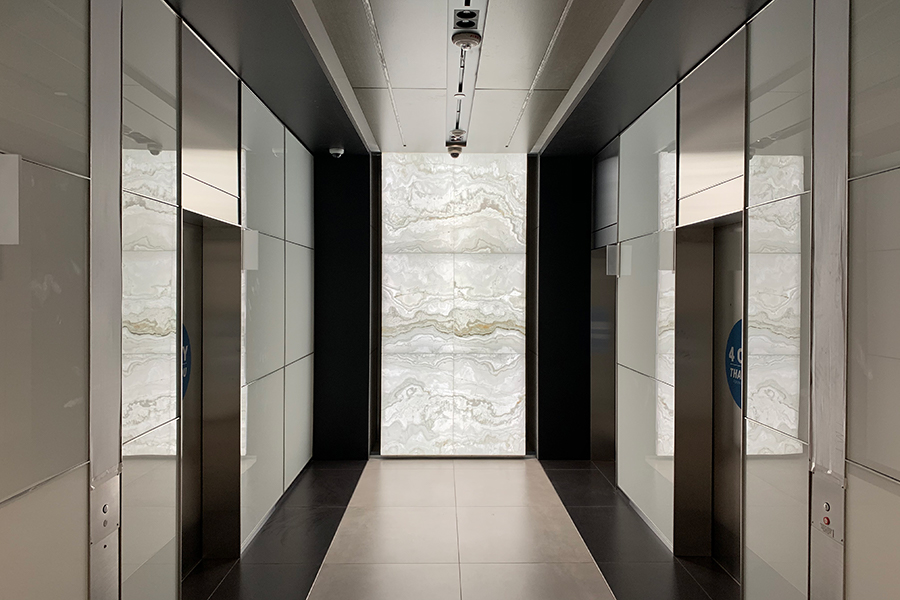 Backlit Onyx Elevator Lobby Walls | GPI Design